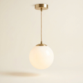 Halo Solo — Single-Globe Pendant in Opal Glass and Brass